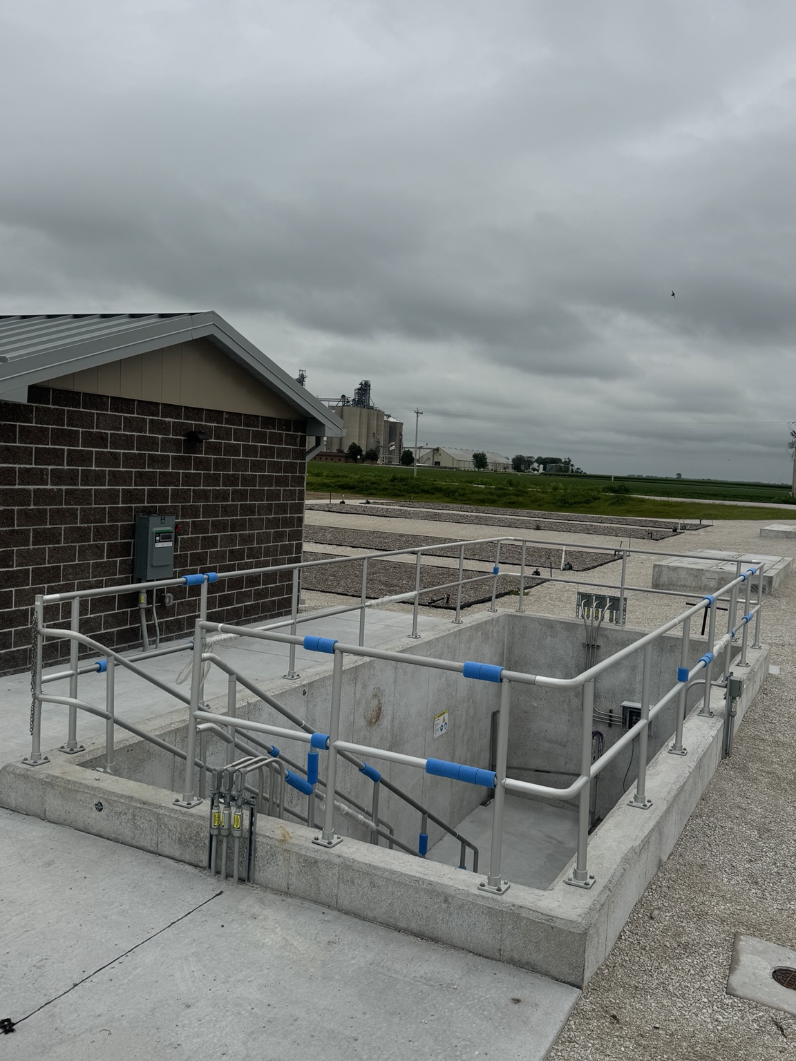 Farnhamville treatment building and concrete structure beside mulch-covered SAGR beds